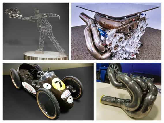 Clockwise from top: Chequered Flag statue, a limited edition Cosworth engine coffee table, Cosworth car part, and Barry Sheene's soapbox car