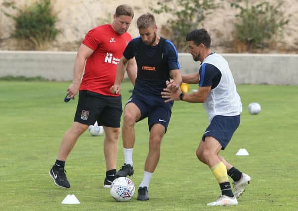 STILL WORKING - Andy Todd watches on as David Buchanan challenges Sam Foley in training on Friday morning. It was the team's final session before returning to the UK (PIcture: Pete Norton)