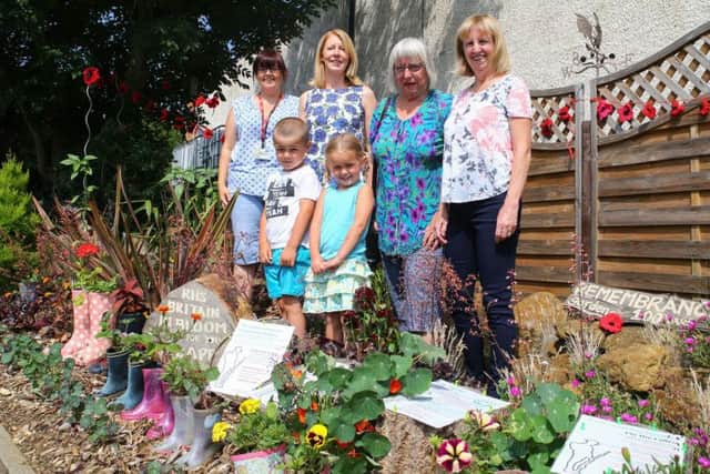 Four of the Cotton Land Girls, all members of Far Cotton Residents' Association, and two nursery pupils, pictured at their 'World War One Wellies' display on Towcester Road.