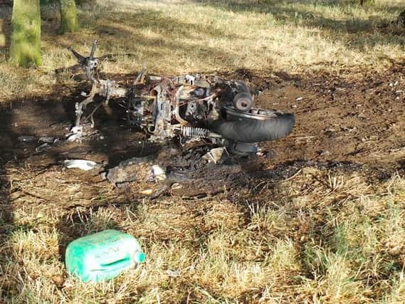 The remains of a burnt out moped and a petrol can have been spotted on a Northampton park.