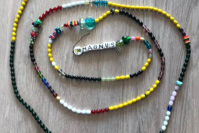 Magnus adds a "bead of courage" to this braid every time he goes for treatment.