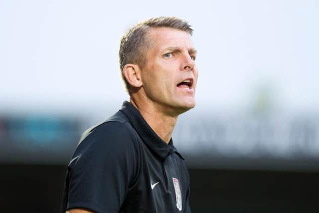 Cobblers boss Dean Austin watches his team see off a Manchester United XI (Picture: Kirsty Edmonds)