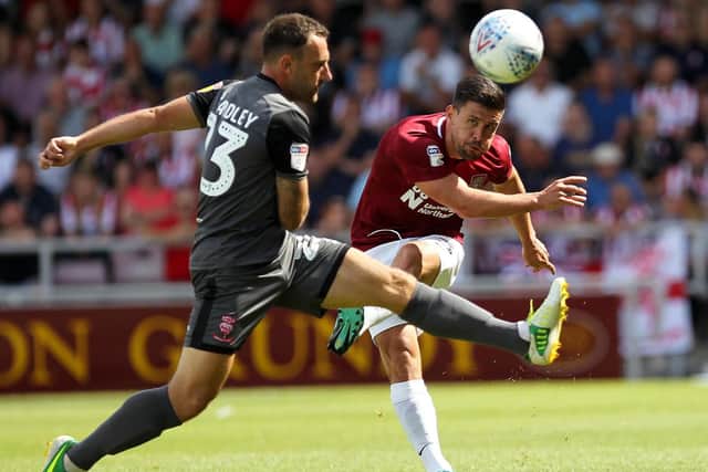 David Buchanan sends in a cross during the Cobblers' defeat to Lincoln City