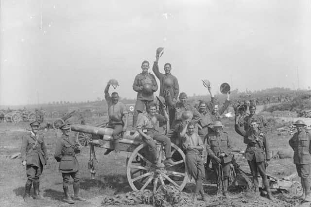 Following the capture of Grevillers by the New Zealand Division, Men of the Royal Garrison Artillery pose beside one of the 4.2 inch guns of a captured battery at Grevillers, 25 August 1918. Note the camouflage netting on the ground, which was designed to prevent the guns from being spotted from the air.