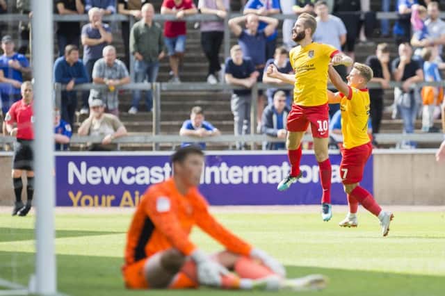 JUMPING FOR JOY: Kevin van Veen finally got his first Cobblers goal at Brunton Park on Saturday. Picture: Kirsty Edmonds