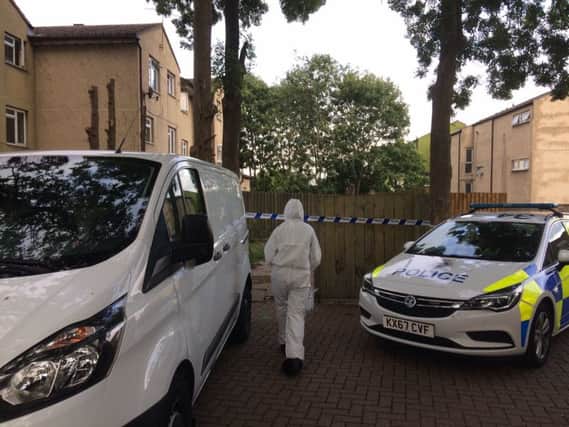 A forensic officer working on the scene of Thomas Gravestock's murder in Corby NNL-180823-190955005