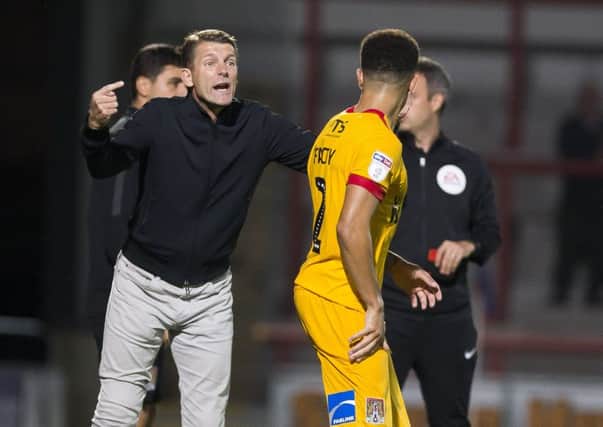 Cobblers boss Dean Austin gives instructions to Shay Facey during Tuesday's defeat at Morecambe