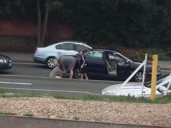 A young boy watched on while the two women carried on their road rage brawl.
