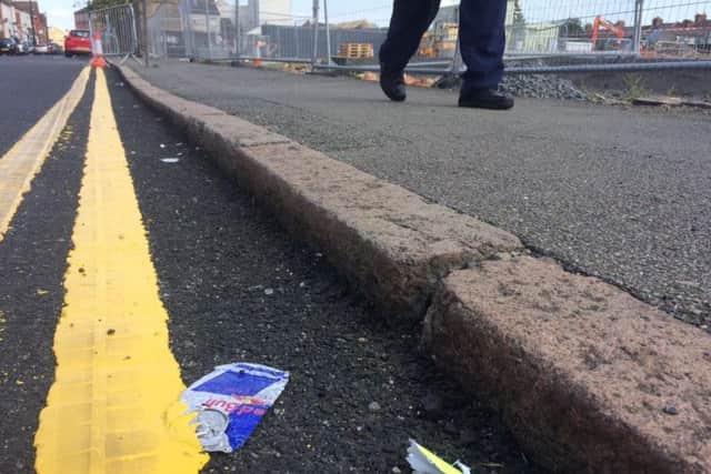Litter on Earl Street has been glued in place after workmen painted straight over the top of it.