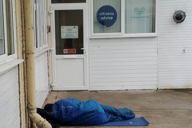 A person in a sleeping bag outside Eastbourne Citizens Advice