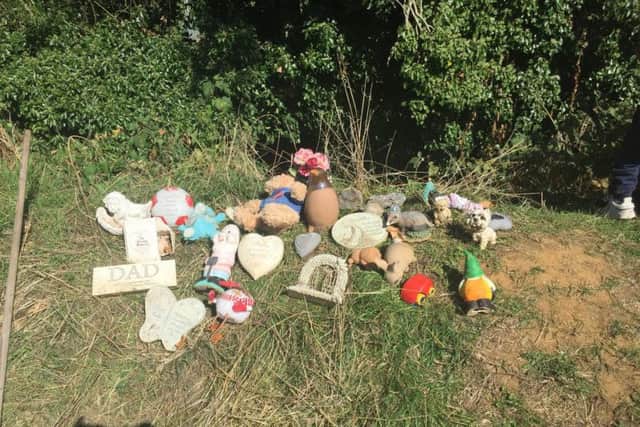 Ornaments from other graves were found thrown in a bush - Kallyann helped to place them together so other people who visit their loved ones can find them.