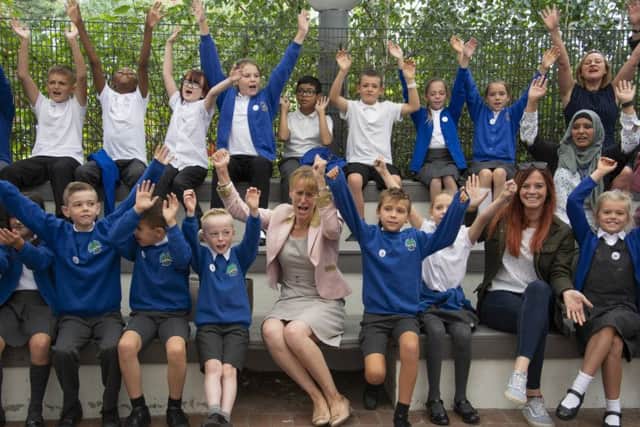 NFU president Minette Batters and NFU member Hannah Jackson celebrate the launch of Farmvention with primary school children