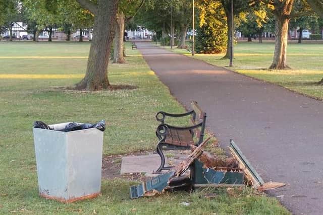 The three bins have been torn out from their bases or smashed to pieces.