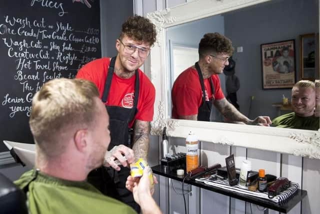 Pictured: Jake Hillery in his first opened barber shop in St James.