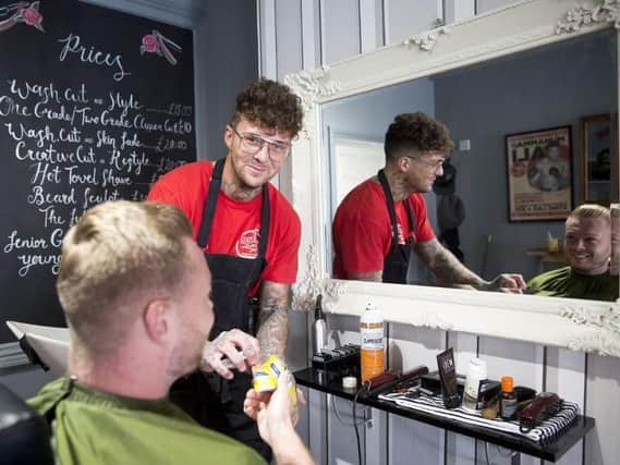 Pictured: Jake Hillery in his first opened barber shop in St James.