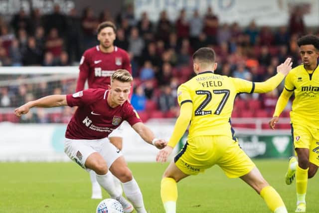 Sam Hoskins takes on his man during the Cobblers' 3-1 defeat to Cheltenham Town (Kirsty Edmonds)