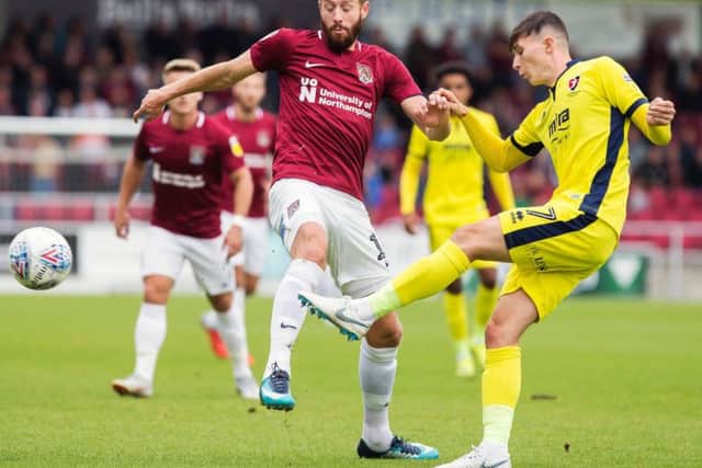 Kevin van Veen makes a challenge in the Cobblers' defeat to Cheltenham