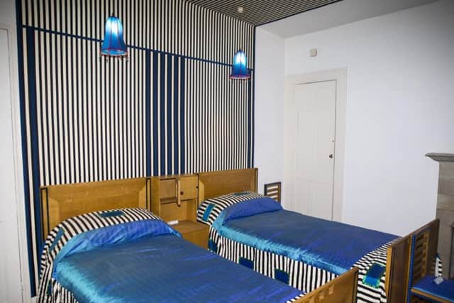 The dazzling furniture and decor of the guest bedroom were designed by Mr Mackintosh - with the blue light shades giving a nod to bluebells.