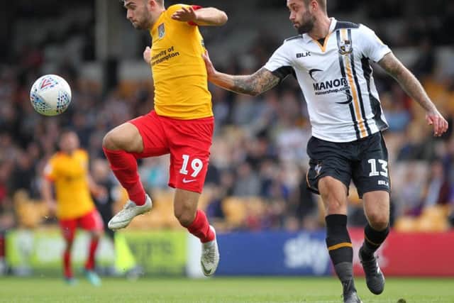 Jack Bridge tries to take on Connell Rawlinson at Vale Park. Picture by Sharon Lucey
