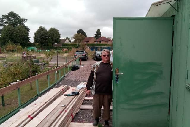 Kevin Garn with one of the containers damaged by burglars during their fruitless spree