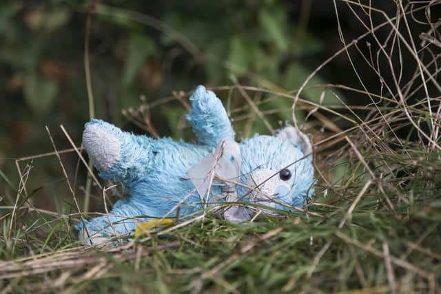 Sally wants Dallington Cemetery to be entirely gated to stop vandals from taking ornaments, including this blue teddy bear, from graves.