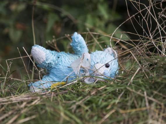 Sally wants Dallington Cemetery to be entirely gated to stop vandals from taking ornaments, including this blue teddy bear, from graves.