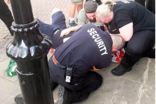 Nathan Loughran and pub door staff help to treat the man before paramedics arrive