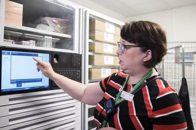Pharmacist Siobhan pictured demonstrating how the finger-print recognition system works in a bid to access the new drugs cabinet.