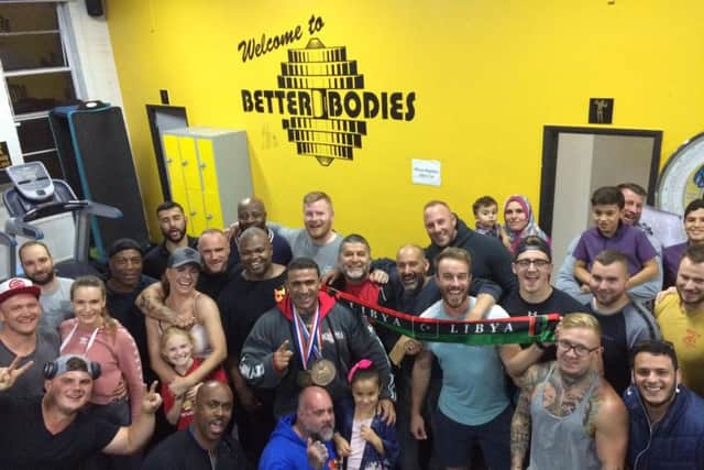Kamal and his members celebrate at his homecoming to the Better Bodies gym.