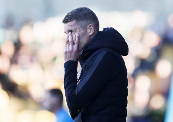 Dean Austin can barely watch as the Cobblers are betaen 4-0 at Mansfield on Saturday