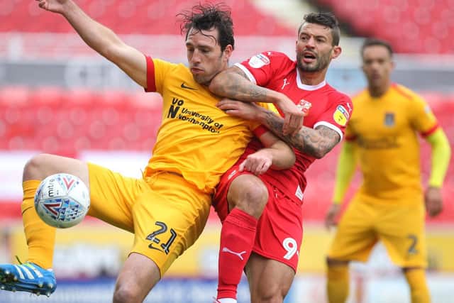 FRIENDS REUNITED: John-Joe O'Toole, who opened the scoring, battles with former team-mate Marc Richards during Saturday's game. Pictures: Sharon Lucey