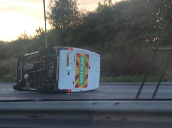 The van was pictured on its side in the middle of the road