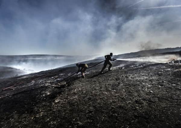 File photo dated 28/6/2018 of firefighters tackle the wildfire on Saddleworth Moor. Firefighters have warned they are under-funded, short-staffed and ill-equipped to deal with an increase in wildfires as new figures show the number of blazes on open ground this summer was more than double the average of previous years. pa/FIRE Summer 07063235.JPG