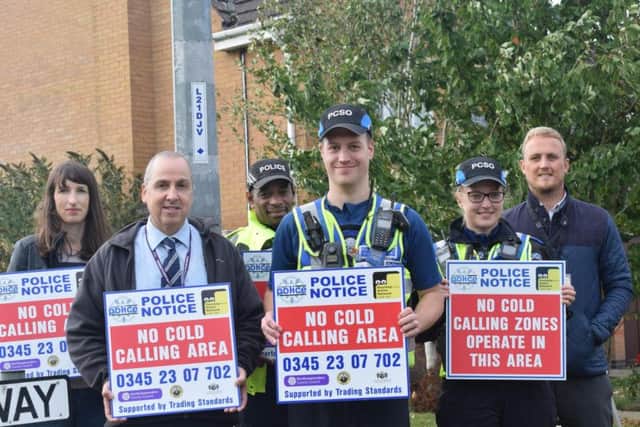 Andrew Langford (second left) with police officers at the launch of the no cold calling zone in Samwell Way