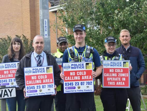Andrew Langford (second left) with police officers at the launch of the no cold calling zone in Samwell Way