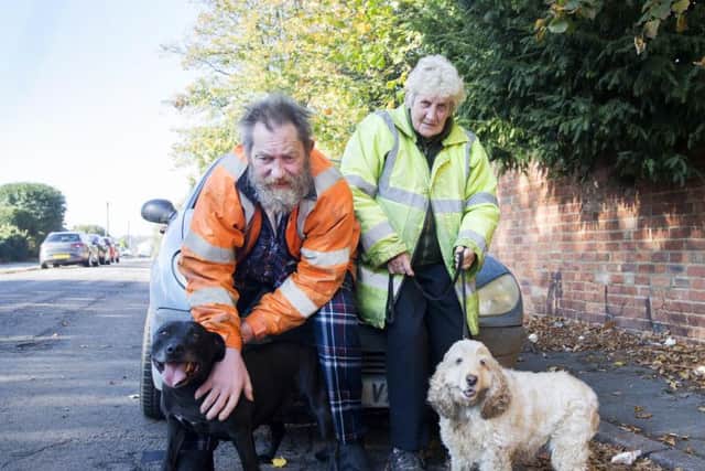Pictured l-r: Nigel Tysoe pictured with staffie Titan, wife Jennifer and cocker spaniel Becky.