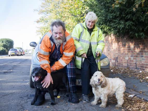 Pictured l-r: Nigel Tysoe pictured with staffie Titan, wife Jennifer and cocker spaniel Becky.