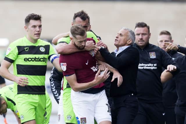 PEACEMAKER: Keith Curle tries to drag Rovers captain Paul Digby away from Kevin van Veen during a late fracas in Saturday's game. Pictures: Kirsty Edmonds