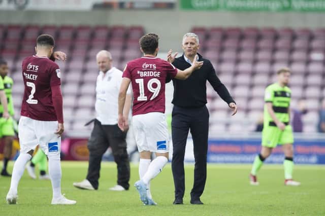 A happy Keith Curle shakes hands with Jack Bridge. Picture: Kirsty Edmonds