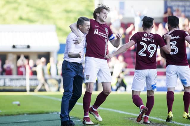 Northampton's 2-2 draw with Oldham in May confirmed both teams' relegation to League Two - despite Ash Taylor, pictured with former manager Dean Austin, putting the Cobblers 2-1 up