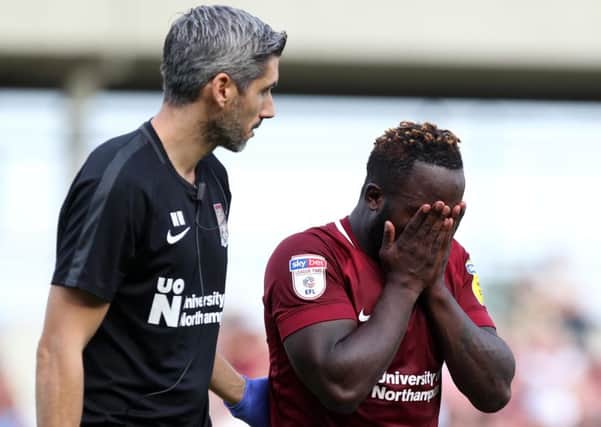 Junior Morias is led off the pitch by physio Nacho Herrando after pulling a hamstring in the 1-1 draw with Tranmere Rovers on September 1. He hasn't played since