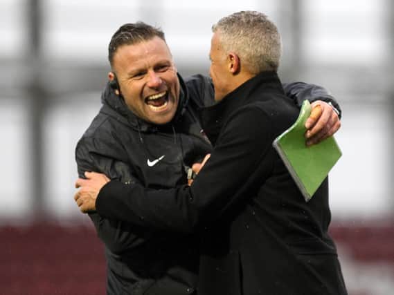 HAPPY KEITH: Town boss Curle and goalkeeping coach Dan Watson celebrate Saturday's nervy victory. Picture: Sharon Lucey