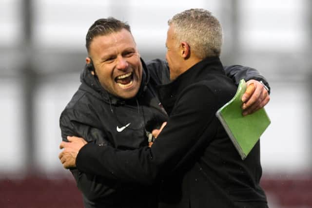 HAPPY KEITH: Town boss Curle and goalkeeping coach Dan Watson celebrate Saturday's nervy victory. Picture: Sharon Lucey