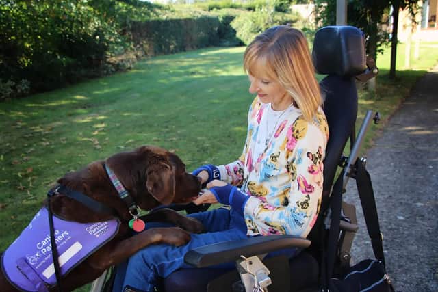 Jackie and Babs. The 55-year-old Northampton woman says her life was transformed by the help of the chocolate labrador.