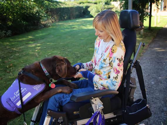 Jackie and Babs. The 55-year-old Northampton woman says her life was transformed by the help of the chocolate labrador.