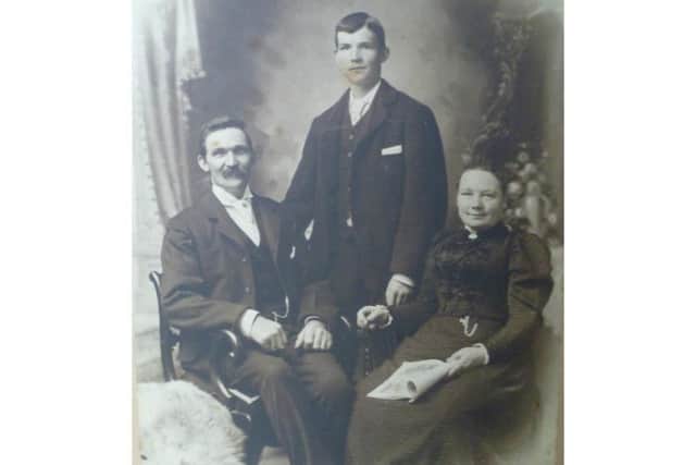 George Maurice Dawkes (centre) with his father Frederick and Matilda
