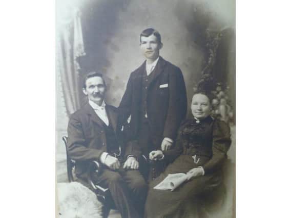 George Maurice Dawkes (centre) with his father Frederick and Matilda