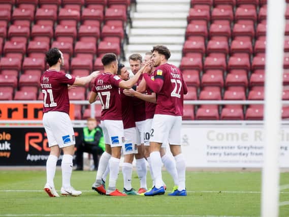 EARLY STRIKE! Cobblers celebrate Andy Williams' 18th minute opener. Pictures: Kirsty Edmonds