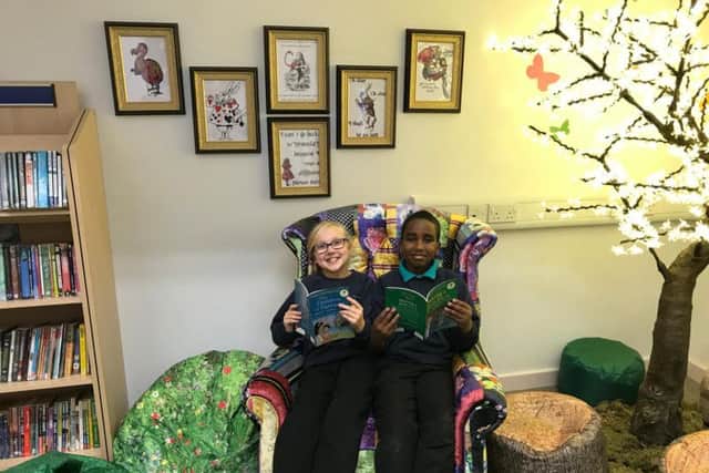 Photo 2 caption: From left, Emily Dale and Suheb Osman in the new storytelling area.
