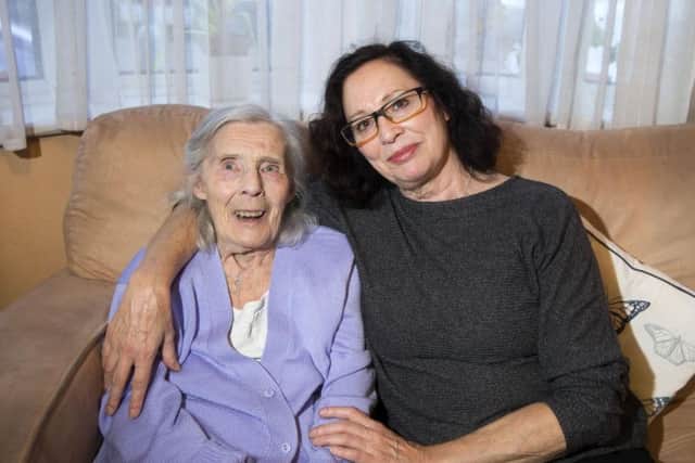 Sylvia Johnson receives support from the Olympus Care specialist dementia team at home. But a review of the service has left her daughter Lynn, right, fearful of her future.